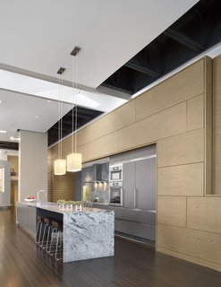 12 Modern Marvels in New England - Photo 11 of 12 - This Boston loft – nearly 5,000 SF with 18-foot high ceilings – presented a number of amazing opportunities and more than a few challenges. Chief among the opportunities was amplifying the immensity of the central living space – perhaps the largest in the city – while making an understandable and livable family house.