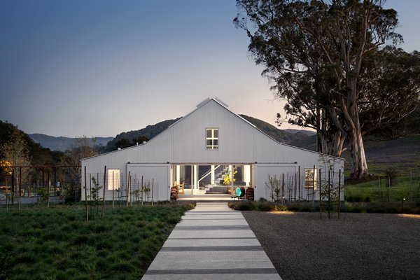 Modern home with outdoor, large patio, porch, deck, trees, garden, shrubs, and back yard. #TurnbullGriffinHaesloop #barn #outdoor #exterior#landscape Photo of Hupomone Ranch