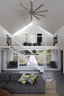 5 Sustainable Ways To Beat the Heat Without Air Conditioning - Photo 6 of 11 - An open mezzanine allows for hot air to rise, and a ceiling fan helps circulate out the hot air.