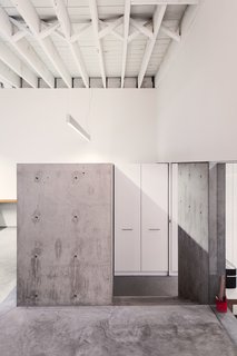 A Creative Agency with a Modern, Open Workspace - Photo 1 of 9 - The walls and ceiling were whitewashed and new concrete was poured to give the workspace a clean and minimal palette. 