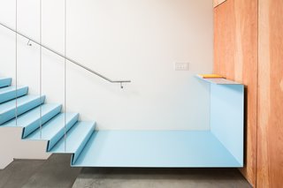 A Creative Agency with a Modern, Open Workspace - Photo 3 of 9 - The staircase has a floating metal landing that connects to a fir plywood wall.