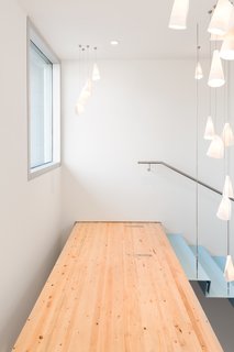 A Creative Agency with a Modern, Open Workspace - Photo 8 of 9 - A fir walkway at the top of the stairs leads to the boardroom.