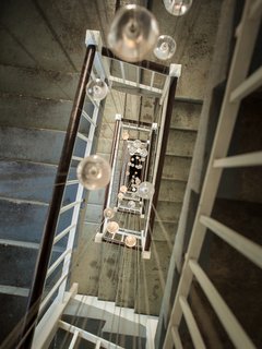 Inside the Head Office of Bocci - Photo 5 of 7 - 120 glass pendants from Bocci’s 14-series illuminate the back staircase.