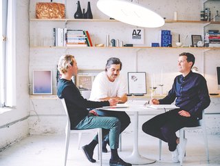 Studio Visit: The Work of ANDlight - Photo 1 of 10 - Heintzman, Davis and Peet sit beneath a Button light in the ANDlight studio. All ANDlight products are designed and hand-assembled in their industrial Vancouver workspace, originally built as a stable in the early century.