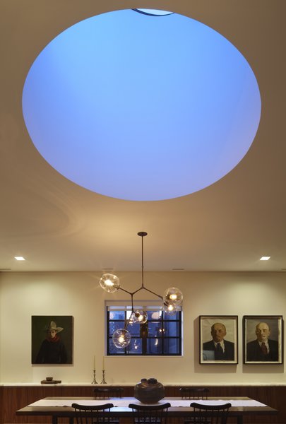 A view of the drum skylight at dusk. Early in the design process we discussed with our clients the work of James Turrell including a field trip to Meeting at MoMA PS1 on a very cold but wonderfully quiet day. One of the things we really like about Mr. Turrell's work is the flattening of perspective while creating a meditative balance between lightness and weight. Here the drum skylight while physically large recedes into the ceiling plan Photo 9 of White Street Residence modern home