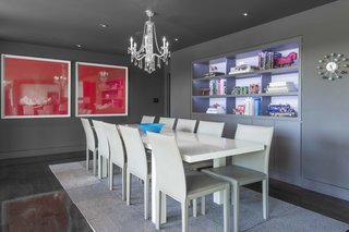 The dining room features built-ins set against a lavender backdrop and artwork by Argentine artist Cristina Fresca. The residents discovered the pieces at a modern art fair in Buenos Aires and shipped them home to Texas.