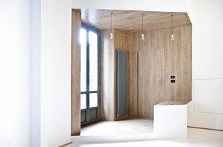 Framed by planes of wood, as well as large pairs of windows, the entryway exudes warmth.