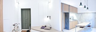 A panorama shows how highlights within the interior landscape define different sections of the apartment, almost a color-coded progression from work to dining to rest.