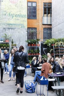 A Retired Copenhagen Power Plant Hosts a Design Pop-Up - Photo 4 of 4 - A plant shop occupies a section of the courtyard, where shop visitors can gather over coffee, pastries, ice cream, and more.