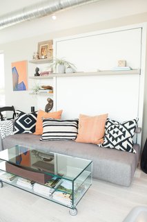 The transforming wall bed system and accompanying glass coffee table by Resource Furniture modeled a space-saving solution for compact quarters. As the home travels from stop to stop, its furnishings evolve to conversate with the aesthetic of the host city. <span style="line-height: 1.8;">For San Francisco, Courtney Lake of Monogram Decor used a palette of blue, orange, and gold to evoke a youthful energy and recall the Golden Gate Bridge spanning bay waters.</span>