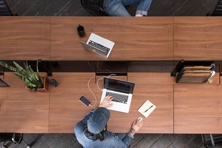 A central channel powers the office while keeping cords and wires out of sight.