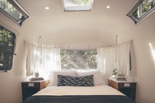AutoCamp’s Modern Clubhouse Emerges from the Russian River Redwoods - Photo 3 of 6 - Airstream suites include queen-sized Casper mattresses with deluxe bedding. The pendant lights are from Schoolhouse Electric.