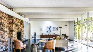 Own a Piece of Hollywood History for $1.995M - Photo 1 of 9 - A rock wall fireplace faces floor-to-ceiling glass panels that provide ventilation during the summer months. Fickett's signature ribbed ceilings accentuate the lines of the home. 