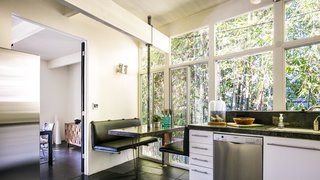 Own a Piece of Hollywood History for $1.995M - Photo 4 of 9 - Booth seating in the eat-in kitchen creates a cozy nook behind a private bamboo fence.