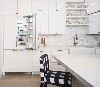 An Interior Designer's Streamlined Kitchen - Photo 6 of 7 - When closed, the integrated fridge becomes flush with the cabinetry. DCS's ActiveSmart Foodcare technology monitors fridge use and adapts the temperature to keep food fresh.