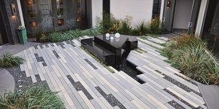 Setting Creative Solutions in Stone - Photo 1 of 6 - Large Scale CalArc Pavers surround an outdoor fountain at this residence. Unlike other producers, Stepstone develops its own molds.