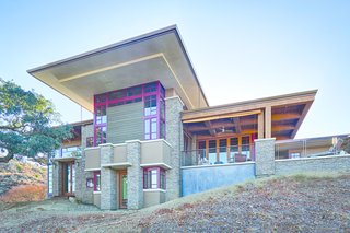 An Architectural Feat in Silicon Valley Tames a Rocky Landscape - Photo 1 of 8 - The deep red aluminum window exteriors are a nod to Frank Lloyd Wright's Fallingwater in Pennsylvania. Wright would visit Brian's mother's restaurant supply store in Madison, Wisconsin, where he picked up necessities to cook for his students.