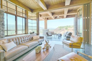 An Architectural Feat in Silicon Valley Tames a Rocky Landscape - Photo 4 of 8 - Tall glass walls fold back to allow an uninterrupted flow of space between the living room and the patio.