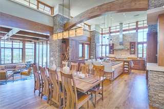 An Architectural Feat in Silicon Valley Tames a Rocky Landscape - Photo 5 of 8 - A few steps up from the living room, the open kitchen features a granite island, walnut cabinets, and stainless steel appliances. The surrounding clerestory windows usher in the light.