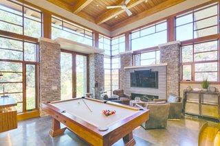 An Architectural Feat in Silicon Valley Tames a Rocky Landscape - Photo 7 of 8 - From the living room, thick oak stair treads suspended on steel stringers descend to the game room, where a walnut bar, Craftsman pool table, and fireplace set the scene for entertaining and lounging.