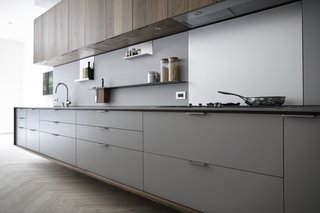 The Whole House System That Unifies Every Room - Photo 1 of 8 - In a Henrybuilt kitchen system, every detail helps orchestrate a streamlined experience. For example, the pulls above protrude to match the plane of the counter and end panels. Drain fields are milled onto work surfaces to fit custom cutting boards and colanders, and low energy LED lights are morticed into the bottom of wall units, which have scoops instead of handles. 