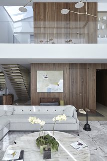 The Whole House System That Unifies Every Room - Photo 3 of 8 - Both functional and aesthetically svelte, this panel and integrated door system hides an elevator and integrated hall storage.