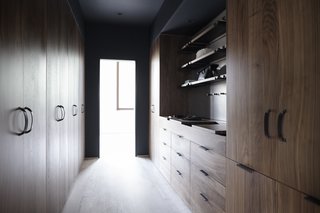 The Whole House System That Unifies Every Room - Photo 8 of 8 - Henrybuilt tailors the Wardrobe System to separate closet functions in a way that meets the needs of the client and the parameters of the architecture. Above, the niche features an Opencase system for added shelving and pegs.