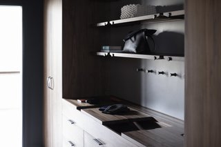 The Whole House System That Unifies Every Room - Photo 7 of 8 - The Wardrobe System features sliding wooden valet trays, leather lined storage compartments, custom interior felt door pockets, handcrafted leather pulls, and an integrated laundry hamper.