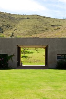 Herman describes the shape of a sleeping dragon nestled in the mountains. In keeping with a Feng Shui philosophy, he intentionally left a hole in the building to allow the beast a clear view of the landscape.