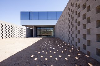 This Sleek Desert Home Seems to Melt Into the Sky - Photo 3 of 12 - Concrete block walls allow light and air to pass into the garden while maintaining a screen of privacy. 