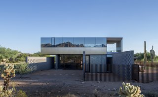 This Sleek Desert Home Seems to Melt Into the Sky - Photo 1 of 12 - Designed by Szu-Ping Patricia Chen Suchart and Thamarit Suchart of Chen + Suchart Studio, the Staab residence stands in stark contrast to its suburban context but in harmony with the Sonoran Desert. 