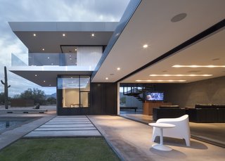 This Sleek Desert Home Seems to Melt Into the Sky - Photo 6 of 12 - Western Window Systems collaborated with the architects to push the boundaries of products like the Multi-Slide Door, seen above. Retracted, it frames domestic views of the pool and backyard and fuses indoor and outdoor space.