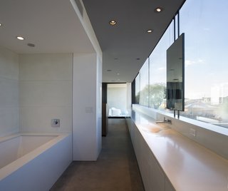 This Sleek Desert Home Seems to Melt Into the Sky - Photo 8 of 12 - The master bathroom and dressing room join the master bedroom as one open suite.