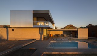 This Sleek Desert Home Seems to Melt Into the Sky - Photo 7 of 12 - The roof overhangs both reduce solar heat gain and create an upstairs patio, allowing the Staabs to overlook the courtyard or out to the distant mountain range.