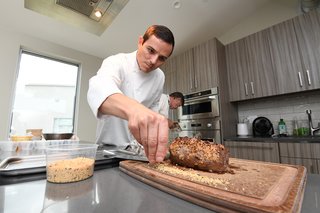 Tour chef Jon Liddell put the finishing touches on his beef tenderloin, cooked to perfection in the French door wall oven.