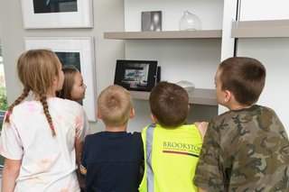 Young visitors watched a video about Resource Furniture, whose Murphy bed was a space-saving solution in the home.