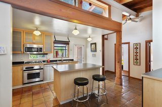 Artists Need Apply: This Midcentury Home Comes With an All-Purpose Workshop for $949K - Photo 4 of 11 - Apart from the side-by-side bathrooms, the layout of the home doesn't reflect its commercial beginnings. The kitchen, which features Saltillo tile flooring, used to be a back office. 