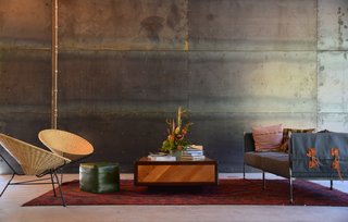 Geremia Design created a texturally rich lounge area, its wood, leather, and textile elements softening the steel backdrop. 