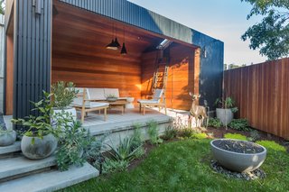 An architect and designer couple rescued their partly-sunken home and transformed a dilapidated garage into a modern living room.