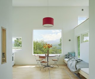 A Mini-Home With Mega-Views - Photo 2 of 4 - A large picture window allows Camel's Hump to hang above the kitchen/work table like a painting. "One of the reasons I love using Marvin is I get great support here in Vermont," says Herrmann. "Marvin does a great job in helping me through a lot of special details, mixing custom things with off-the-shelf windows; we feel like we can push the boundaries."