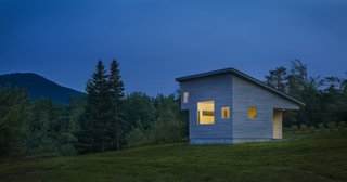 A Mini-Home With Mega-Views - Photo 4 of 4 - Built to stay cozy through all kinds of weather, Micro House has a gray-stained, cedar rain screen in addition to Lo-E glass. At a diagonal from the front porch, another subtracted corner makes space for a sleeping loft.