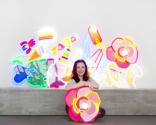 Next-Generation Neon - Photo 1 of 7 - Natalie Jarvis poses with her creations. When she initially conceived of Electric Confetti, she had considered using traditional neon, but its fragility and the presence of mercury drove her to research other alternatives—leading to her discovery of LED neon flex.