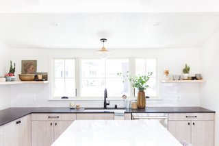 The Big Reveal: An Interior Designer Unveils Her “No Ordinary Kitchen” Makeover - Photo 7 of 9 - A white undermount sink and a matte black faucet are functional, refined elements. "The one thing I did love about the previous kitchen was the large window over the sink, and that's the only design element we chose to keep," says Lewis.