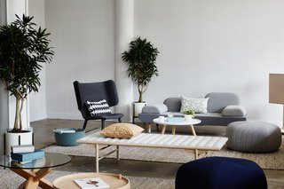 The Tembo Lounge Chair by New Works and an EJ 123 Toward Sofa by Erik Jorgensen lend their sculptural presence to the lounge area, while textiles by Ferm Living and Five Poufs by Muuto provide a counterbalancing softness. The glass-top Ding Table is by Normann Cophagen, and the Align Daybed is by Menu. 