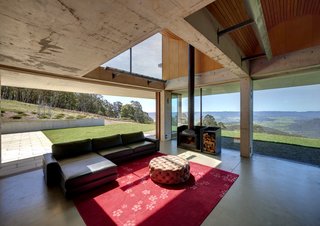 A wood-burning stove and hydronic and geothermal heating systems ensure that this residence is warm and inviting, despite its openness to the outdoors.