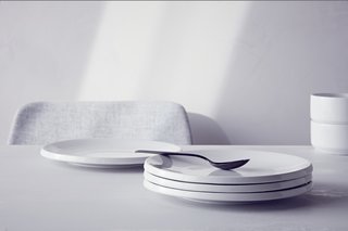 The Stoneware Glazed Plate ($39.99 for a set of four) has a lip that makes it seem to hover above the table.