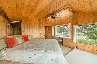 Settle in the Celebrated Sea Ranch For Under $2.9M - Photo 5 of 11 - The angular master bedroom benefits from plenty of windows, including a skylight above a built-in vanity.