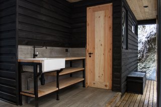 Just Getting to This Remote Patagonian Retreat Is an Adventure - Photo 7 of 8 - Behind the house, a fish cleaning station leads to the laundry room and a storage room.