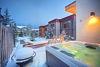 Be at Home With Park City’s Slopes For $1.6M - Photo 2 of 8 - The lower deck holds a fire pit and hot tub, perfect for outdoor entertaining despite the cold. 