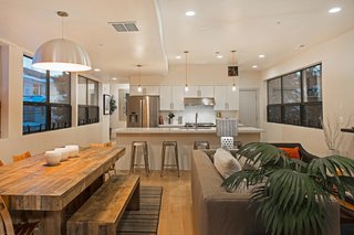 Be at Home With Park City’s Slopes For $1.6M - Photo 3 of 8 - Preston and his friends at Icon Homes opted for an open floor plan that integrates the living, dining, and kitchen areas. "We went for a monochromatic look," says Preston. White oak plank flooring runs throughout the entire home.